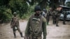 FILE - A Democratic Republic of Congo soldier is seen on patrol in the village of Manzalaho, near Beni, Feb. 18, 2020, following an alleged attack by members of the Allied Democratic Forces (ADF) rebel group.