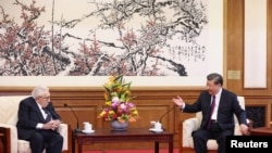 Chinese President Xi Jinping and Henry Kissinger, former U.S. secretary of state, attend a meeting in Beijing