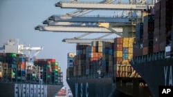 FILE - Container ships are seen at the Port of Savannah, Georgia, Sept. 29, 2021. A World Trade Organization arbitrator has decided that China can impose tariffs on imports from the United States totaling up to $645 million a year, capping a decade-long d