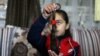 Palestinian cancer patient Tala Al-Mabhouh, 11, who had a bone marrow transplant, shows a part of her hair which she lost due to chemotherapy, in Rafah in the southern Gaza Strip, Feb. 2, 2021.