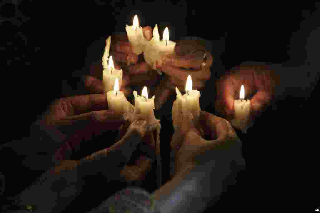 People pay tribute to the victims of an overnight attack on the Quetta Police Training Academy during a vigil in Lahore, Pakistan. Militants wearing suicide vests stormed the police academy in the southwestern city of Quetta overnight, killing dozens of people, mostly police cadets and recruits, and waging a ferocious gun battle with troops that lasted into early hours Tuesday.