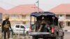 FILE - A police vehicle drives through Yola, in Adamawa state, Nigeria, Feb. 15, 2019. A Nigerian reporter has died after being found Jan. 15, 2020, bound and gagged in a farmer's field in the area.