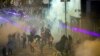 Protesters react from tear gas fired by riot policemen during the anti-extradition bill protest at Causeway Bay in Hong Kong, Aug. 4, 2019.