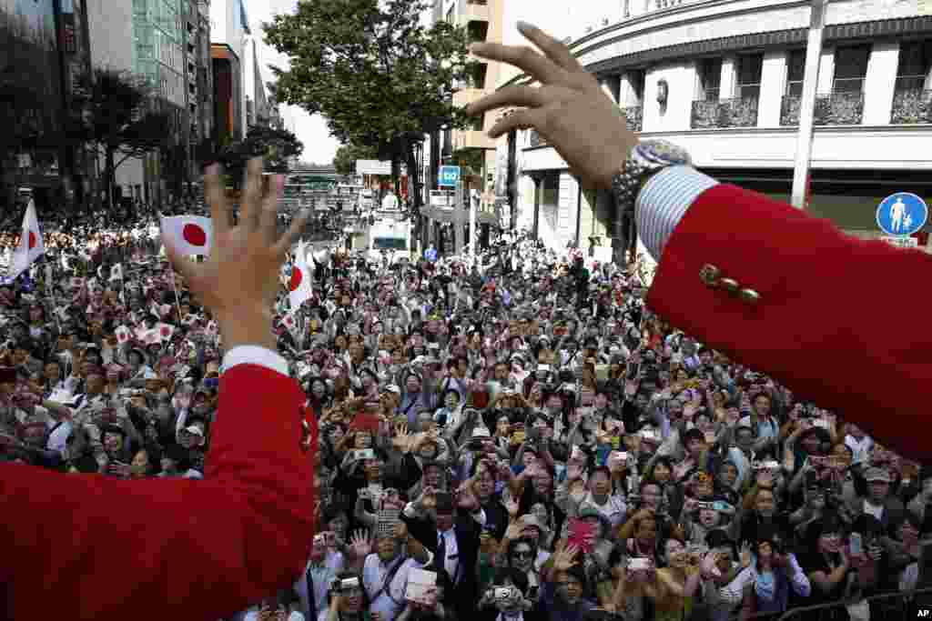 Japanese medalists of the Rio de Janeiro Summer Olympics wave from a bus to cheering people during a parade in Tokyo&#39;s Ginza district. Tokyo will host the 2020 Olympics and Paralympics.