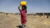 A girl carries a canister of cooking oil she received from the local charity Mona Relief at a camp for internally displaced people on the outskirts of Sana'a, Yemen March 1, 2021.
