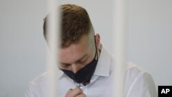 Finnegan Lee Elder touches a crucifix he has around his neck before a jury began deliberating the fates of Elder and his co-defendant Gabriel Natale-Hjorth, in Rome, May 5, 2021.