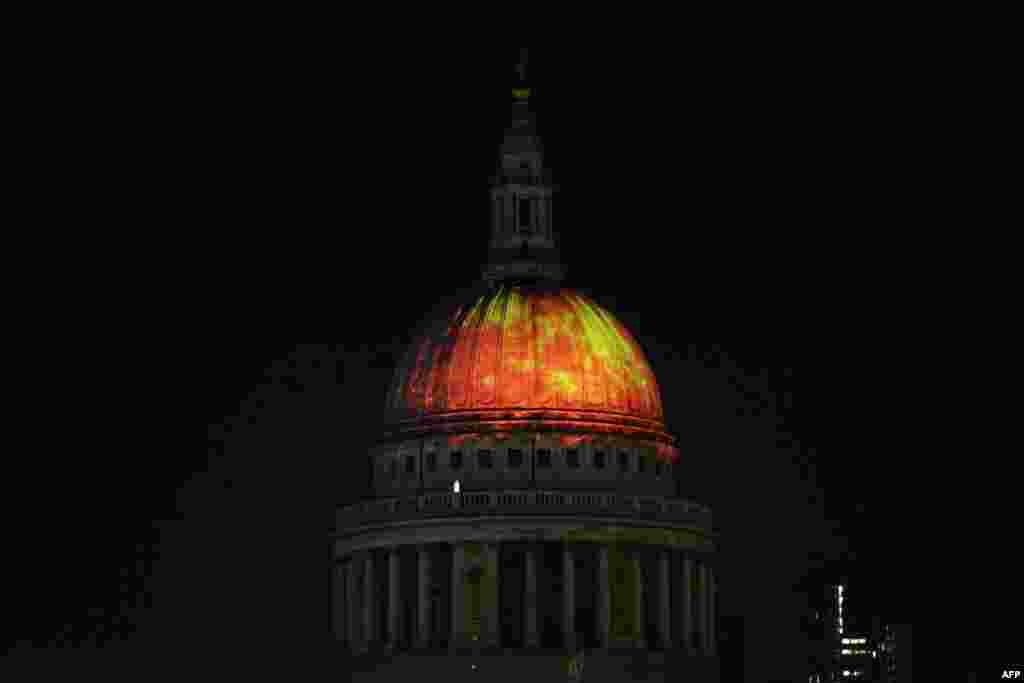 The dome of St. Paul's Cathedral is lit up with a fiery projection during a rehearsal of artist Martin Firrell's "Fires of London: Fires Ancient" ahead of the London's Burning festival commemorating the 350th anniversary of the Great Fire of London.