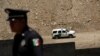 A Mexican police officer stands next to a bollard-type wall along the border of a private property, built using funds raised from a GoFundMe account, at Sunland Park, New Mexico, as a border patrol vehicle is seen, from Ciudad Juarez Mexico May 29, 2019…