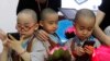 Young boys operate smartphones, May 15, 2013.