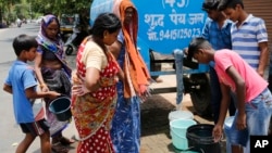 Indians collect drinking water from a mobile water tanker on a hot summer day in Prayagraj, India, Saturday, June 15, 2019. Many parts of India are experiencing extreme heat conditions. 
