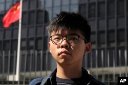 FILE - Pro-democracy activist Joshua Wong stands outside the Legislative Council building in Hong Kong, Nov. 28, 2019.