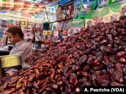 Vendor selling dates and traditional food items at a market in a Muslim dominated neighborhood in Delhi.