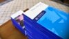In this photo provided by the Australian Government Royal Commission, the volumes of the Final Report of the Royal Commission into Institutional Responses to Child Sexual Abuse sit on a table at Government House, in Canberra, Dec. 15, 2017.