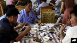 Food served on a table during lunch time at Pyongyang House of Sweet Meat, a restaurant specialized in dishes made of dog meat, in Pyongyang, North Korea, July 25, 2018. 
