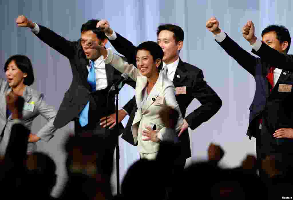 Japan's main opposition Democratic Party's new leader Renho (C) raises her fists with her party lawmakers after she was elected party leader at the party plenary meeting in Tokyo.