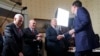 FILE - Vice President Mike Pence, left, and Secret Service Director Joseph Clancy stand as President Donald Trump shakes hands with FBI Director James Comey during a reception for inaugural law enforcement officers and first responders in the Blue Room of