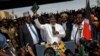 Opposition leader Raila Odinga holds up a bible during a "swearing-in" ceremony at Uhuru Park in downtown Nairobi, Kenya, Jan. 30, 2018.