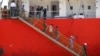FILE - Afghan migrants walk down the stairway of a tanker that rescued them at a port in Cilegon, Banten province, Indonesia, Apr. 9, 2012. Indonesia said it had rescued 120 Afghan migrants from a leaking wooden ship headed to Australia after receiving a distress call from the ship's captain on Sunday and went to their aid. 