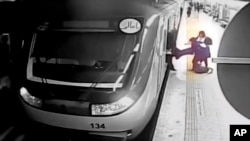 In this image from surveillance video aired by Iranian state television, women pull 16-year-old Armita Geravand from a train car on the Tehran Metro in Tehran, Iran, on Oct. 1, 2023. Coverage of Geravand's death has resulted in journalists' arrests.