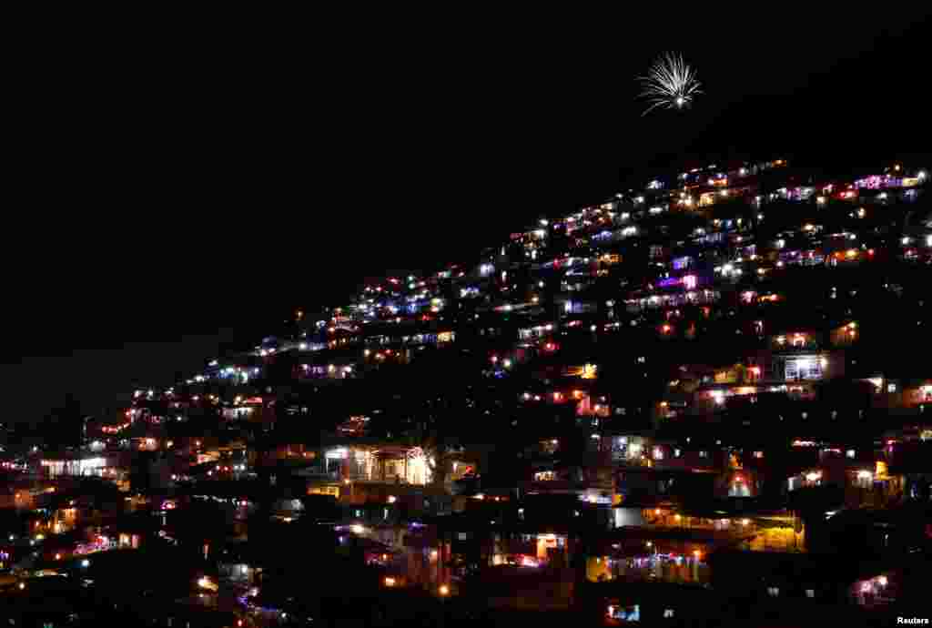 People decorate their houses with lanterns and lights as they celebrate the annual Hindu festival of Diwali in Mumbai, India, Oct. 30, 2016.