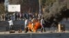 Zimbabweans protest in downtown Harare, Zimbabwe, Wednesday Aug. 1, 2018. Zimbabwe's electoral commission said it would say "sometime tomorrow" when it can start announcing the results of the race pitting President Emmerson Mnangagwa and Nelson Chamisa of the MDC Alliance.