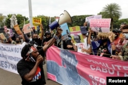 Aktivis Papua saat aksi unjuk rasa menyerukan hak mereka untuk menentukan nasib sendiri di Jakarta , 1 Desember 2021. (Foto: REUTERS/Willy Kurniawan)