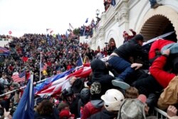 FILE - Supporters of then-President Donald Trump storm the U.S. Capitol to contest the certification of the 2020 presidential election results by Congress, in Washington, Jan. 6, 2021.
