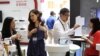 Vendors explain their products on the opening day of the Computex exhibition at the Taipei World Trade Center in Taipei, Taiwan, June 5, 2012.