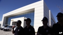Police officers are seen outside the premises of Koza Ipek Holding, a media group close to U.S.-based moderate Islamic cleric Fethullah Gulen, in Ankara, Turkey, Sept. 1, 2015.