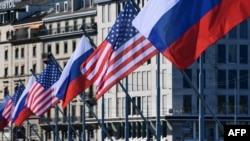Bendera AS dan Rusia berkibar di jembatan Mont-Blanc pada malam KTT AS-Rusia, pada 15 Juni 2021 di Jenewa. Sebuah surat kabar Selasa mengklaim bahwa diskusi mengenai senjata nuklir strategis antara AS dan Rusia sedang disusun. (Foto: AFP)