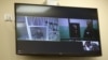 A screen shows jailed Kremlin critic Alexei Navalny as he arrives to listen to an appeal hearing against a court decision to jail him for 19 years in a maximum security prison on extremism-linked charges, at a court in Moscow on Sept. 26, 2023.