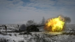 A Russian army service member fires a howitzer during drills at the Kuzminsky range in the southern Rostov region, Russia Jan. 26, 2022.