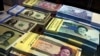 FILE - Iranian and U.S. banknotes are on display at a currency exchange shop in downtown Tehran, Iran, on April 4, 2015.