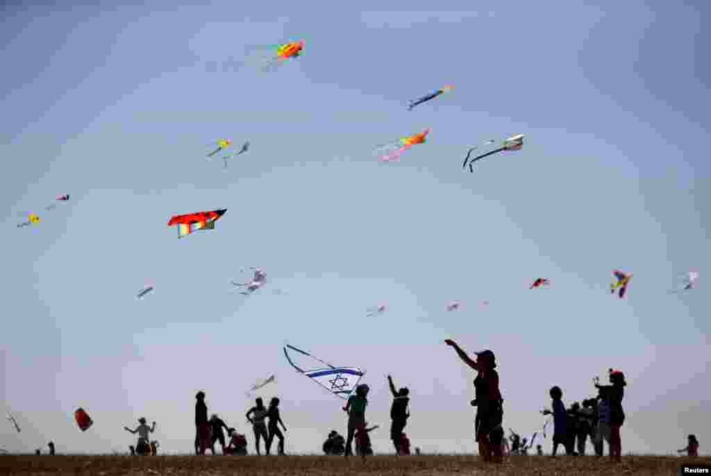 Israelis fly kites during the Rosh Hashanah holiday, the first two days of the Jewish new year, in Beit Guvrin National Park near the city of Kiryat Ga.
