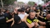 FILE - Police block Georgian opponents of gay rights as they try to interfere with a pride event in Tbilisi on July 8, 2023. Georgia's parliament on June 27, 2024, advanced several anti-LGBTQ+ bills.