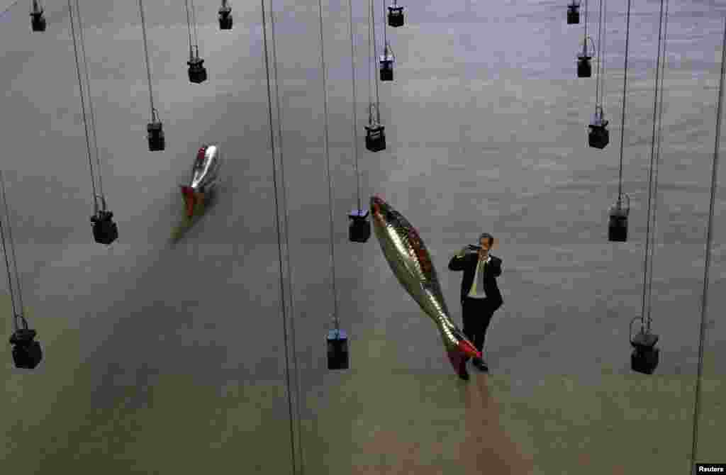 A man takes a picture of the installation &quot;Anywhere&quot; by French artist Philippe Parreno, in the Turbine Hall at Tate Modern in central London, Britain.