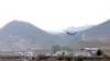 In this photo provided by Islamic Republic News Agency, IRNA, the helicopter carrying Iranian President Ebrahim Raisi takes off at the Iranian border with Azerbaijan after President Raisi and his Azeri counterpart Ilham Aliyev inaugurated a dam in Azeri, Iran, May 19, 2024. 