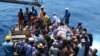 Residents wait on a raft to board a boat as they are evacuated from the Pacific island of Ambae, which is part of Vanuatu on Wednesday Sept. 27, 2017.
