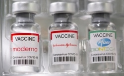 FILE PHOTO: Vials labelled "Moderna, Johnson & Johnson, Pfizer-BioNTech coronavirus disease (COVID-19) vaccine" are seen in this illustration picture taken May 2, 2021