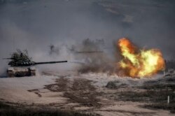 A Russian army T-72-B3 tank fires during military exercises at the Raevsky range in Southern Russia on September 23, 2020 during the "Caucasus-2020" military drills gathering China, Iran, Pakistan and Myanmar troops, along with ex-Soviet Armenia, Azerbaij
