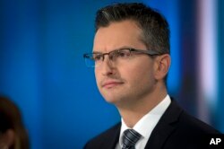 Marjan Sarec, former actor and a candidate at upcoming presidential elections, looks at his counter-candidates ahead of a televised debate at Slovenia's public TV, in Ljubljana, Slovenia, Oct. 19, 2017.