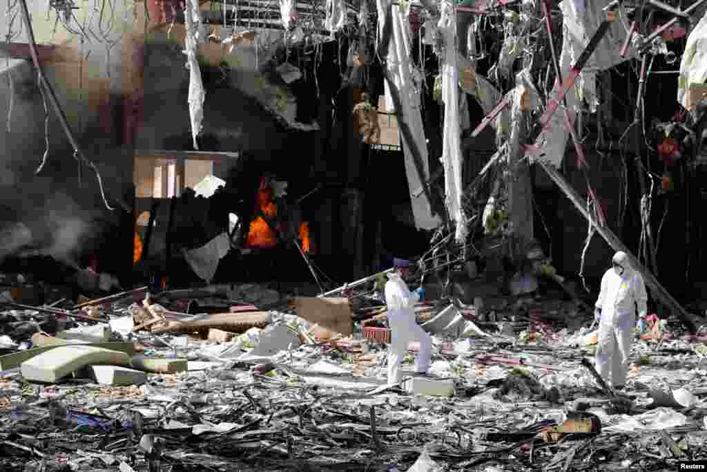 Forensic experts investigate the scene at the community hall where Saudi-led warplanes struck a funeral in Sana'a, the capital of Yemen.
