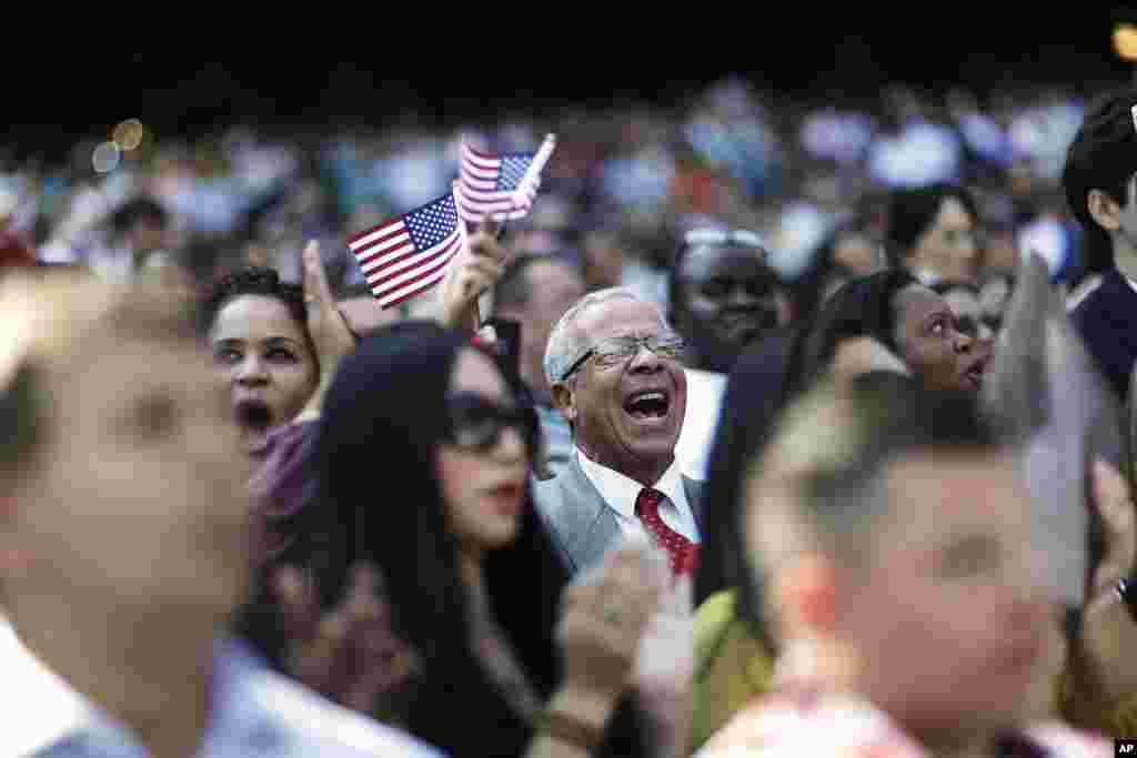 Alfonso Perez, of the Dominican Republic, cheers at the start of a naturalization ceremony for 755 new United States citizens at Turner Field, home of the Atlanta Braves baseball team in Atlanta, Georgia. Saturday marks Constitution Day and Citizenship Day in the U.S.