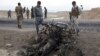 Afghan security forces gather at the site of Monday's suicide attack near the Bagram Air Base, north of Kabul, Afghanistan, April 9, 2019. 