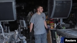 FILE - Workers remove debris inside a supermarket damaged by a Russian missile strike, amid Russia's attack on Ukraine, in Dnipro, Ukraine July 1, 2024. 