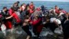Refugees arrive on a dinghy after crossing from Turkey to Lesbos island, Greece, Sept. 8, 2015.