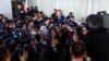 FILE - Then-President Mauricio Macri talks to journalists after casting his vote during primary elections in Buenos Aires, Argentina, Aug. 11, 2019.