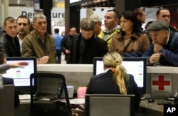 People gather at the airline information desk at of Russian airline Kogalymavia’s desk at Pulkovo airport in St.Petersburg, Russia, Oct. 31, 2015,