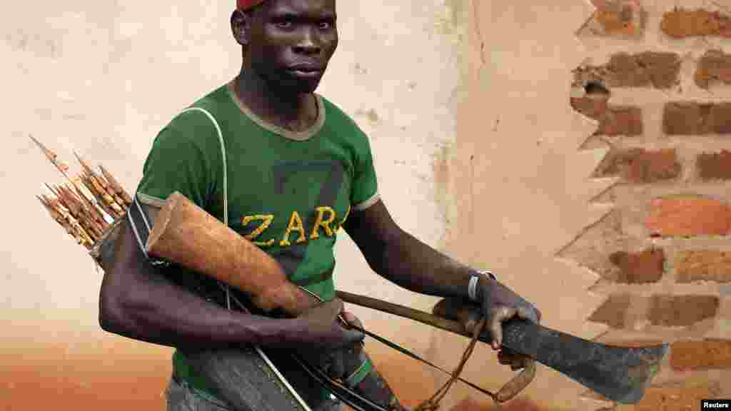 A member of the anti-balaka, a Christian militia, walks with his weapons in village of Zawa, Central African Republic, April 8, 2014.
