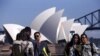 FILE - Chinese tourists taking pictures of themselves in front of the Sydney Opera House in Sydney, Australia.